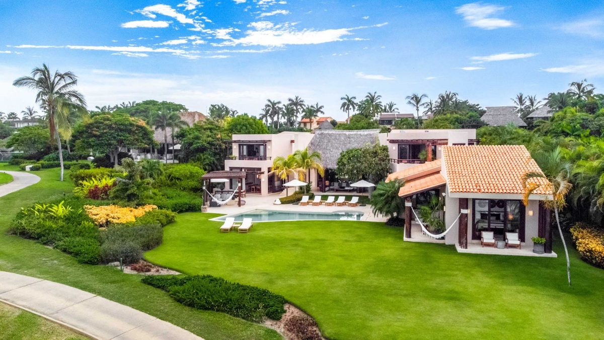 Aerial view of Casa Caída de Agua showcasing tropical gardens, luxury architecture, and expansive outdoor spaces
