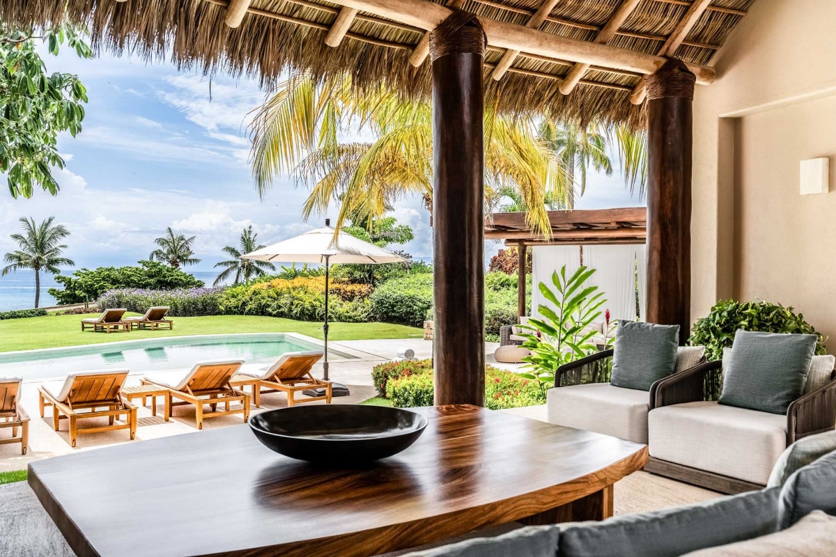 Luxury indoor outdoor lounge at Casa Caída de Agua with panoramic tropical views and elegant decor