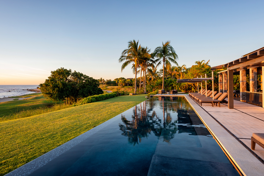 Luxury beachfront villa Casa Vatule in Punta Mita featuring a large infinity pool merging with the Pacific Ocean horizon.