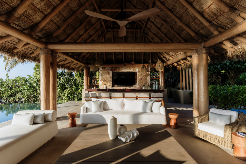 Dramatic cliffside architecture of Casa Entre Rocas, a luxury oceanfront villa in Mexico with private beach access.